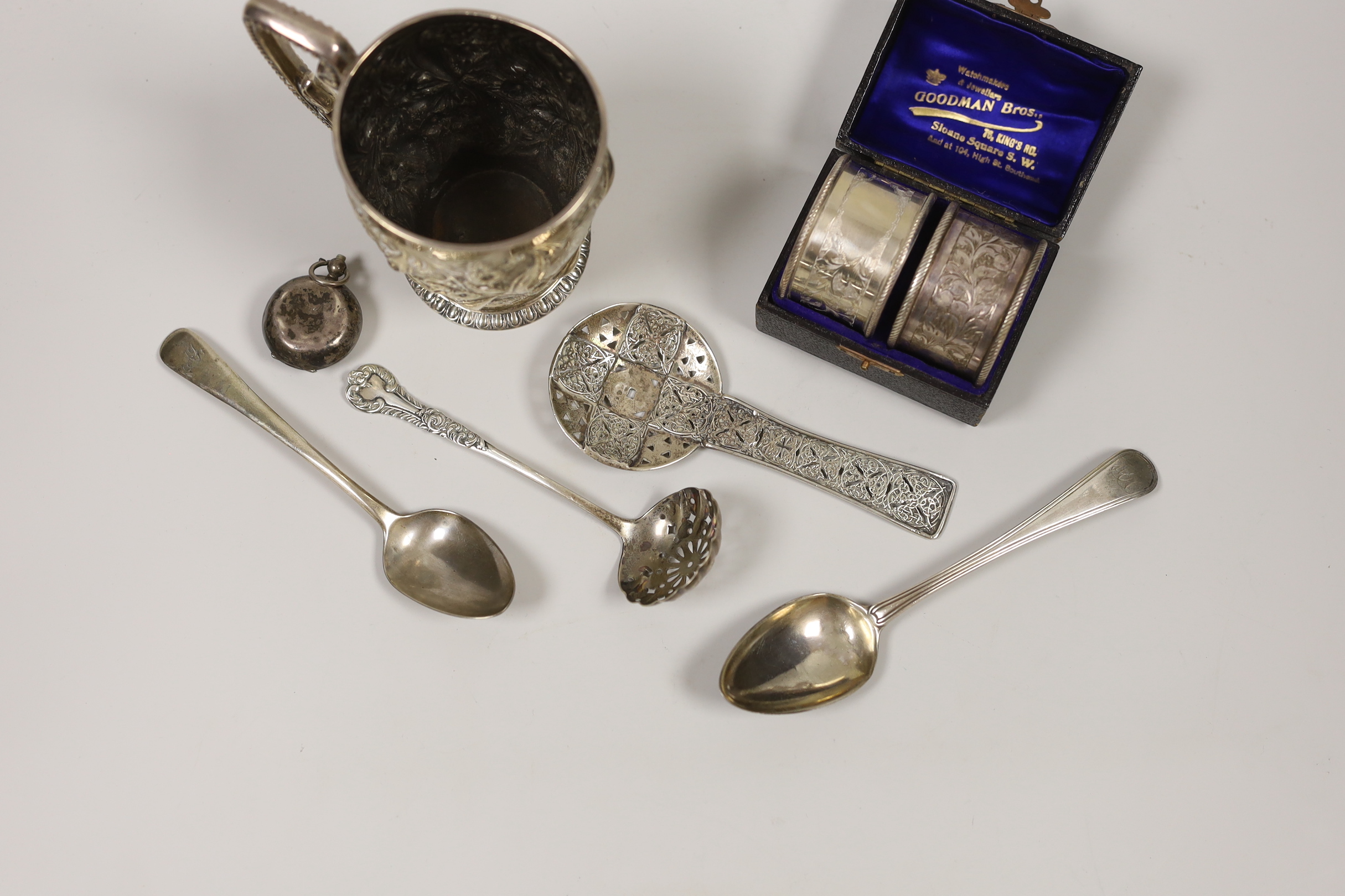 Sundry small silver including a Victorian embossed silver christening mug, London, 1894, 10cm, a pierced spoon by Amy Sandheim Ltd, London, 1938, a cased pair of silver napkin rings and four other items.